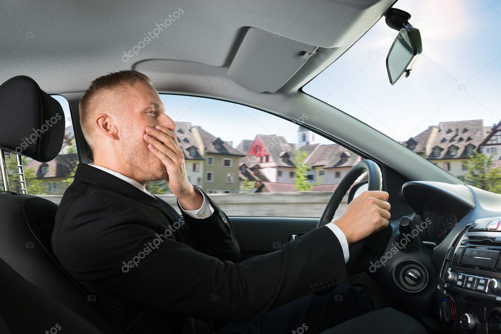 Businessman Yawning in Car