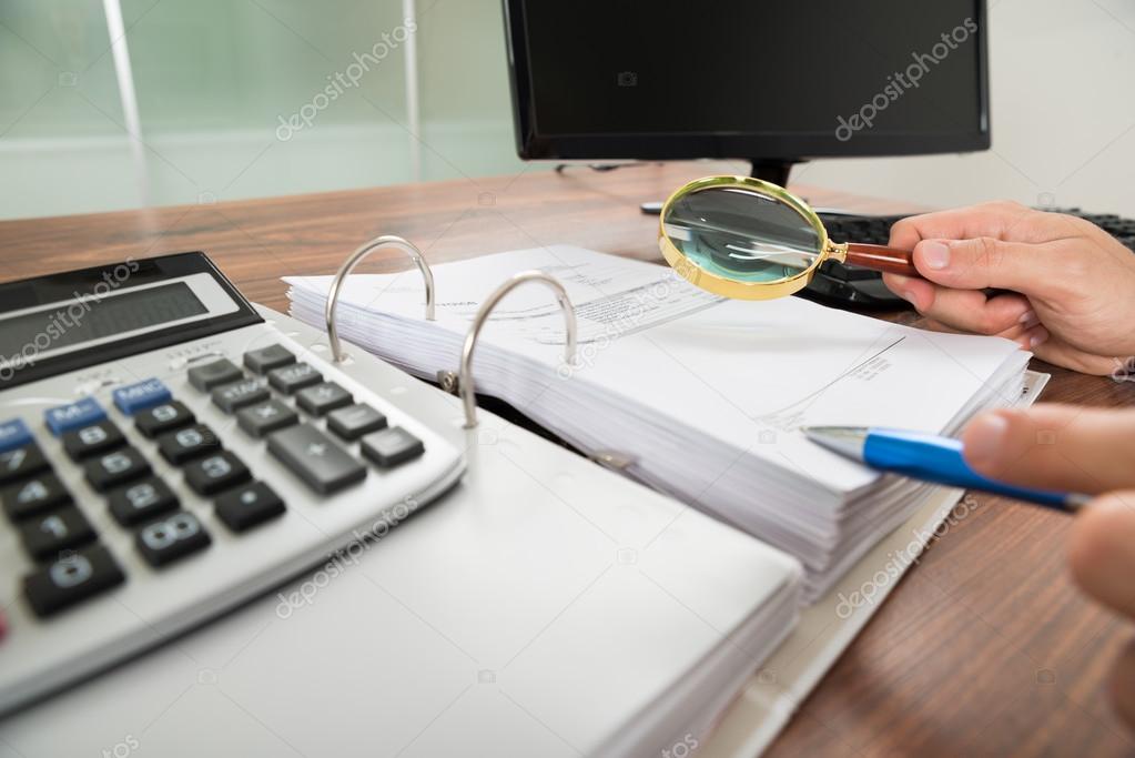 Hand Holding Magnifying Glass