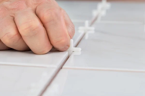 Hand Placing Spacers Between Tiles — 图库照片
