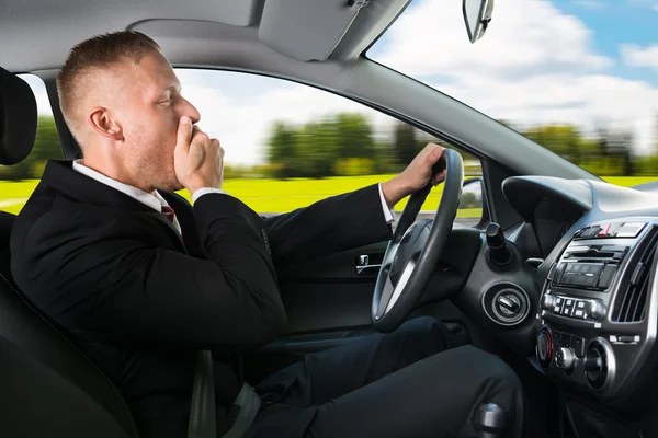 Businessman Yawning While Driving Car — Stock Photo, Image