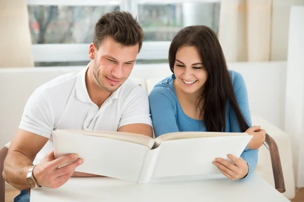 Couple looking in big book — Stock Photo, Image