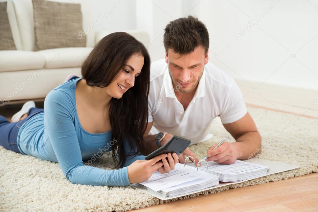 Young Couple Calculating Invoice