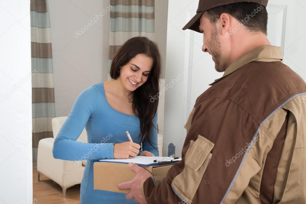 Woman Signing While Receiving parcel