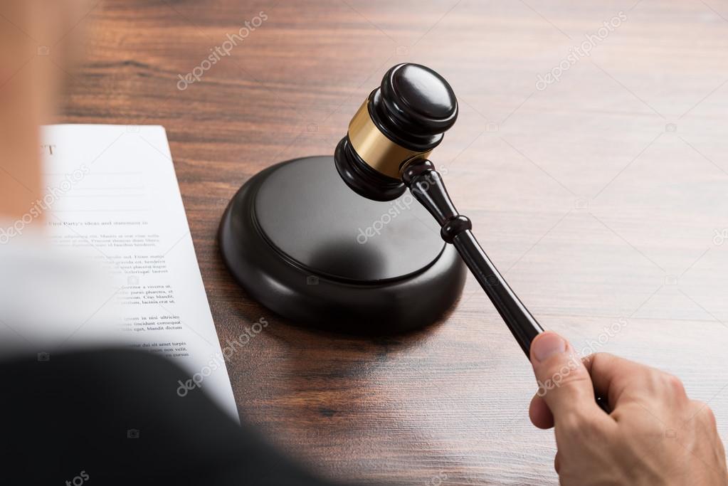 Judge Hitting Gavel At Desk Stock Photo by ©AndreyPopov 74748101