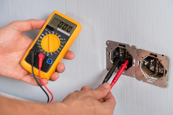 Person Hand Checking Socket Voltage — Stock Photo, Image