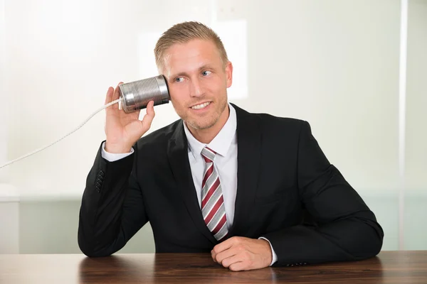 Businessman Listening with Tin Can Phone — Stock Photo, Image