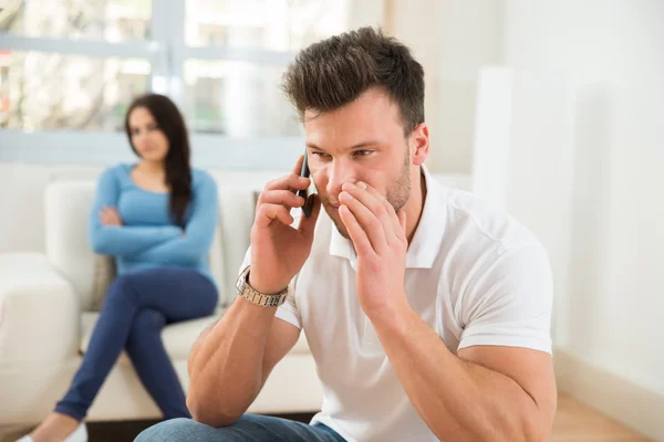 Husband Talking Privately On Cellphone — Stock Photo, Image