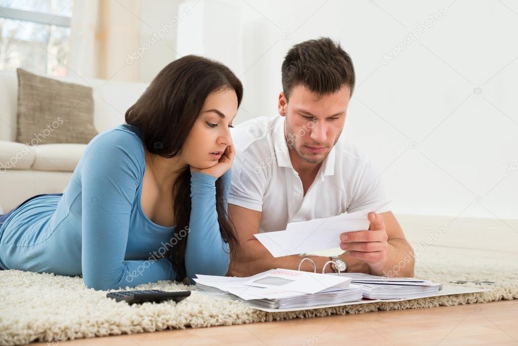 Worried Couple Calculating  Bills At Home