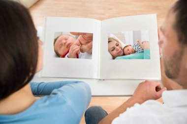 Couple Looking At Photo Album