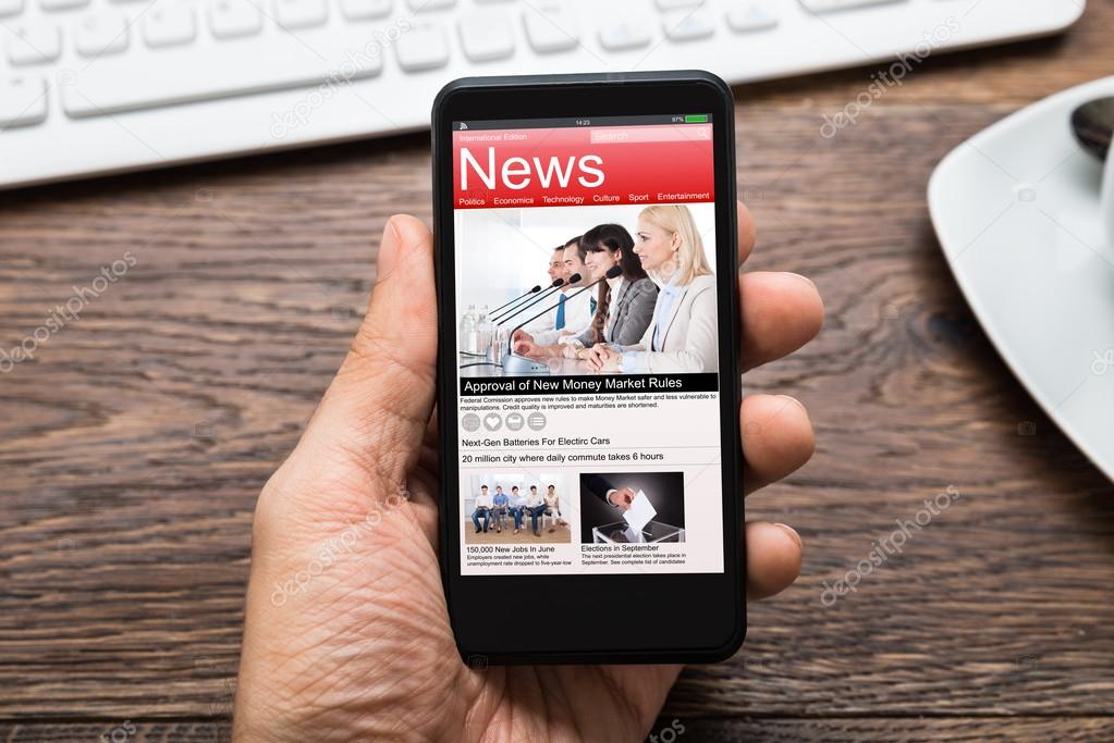 Hand With Mobile Phone Showing News