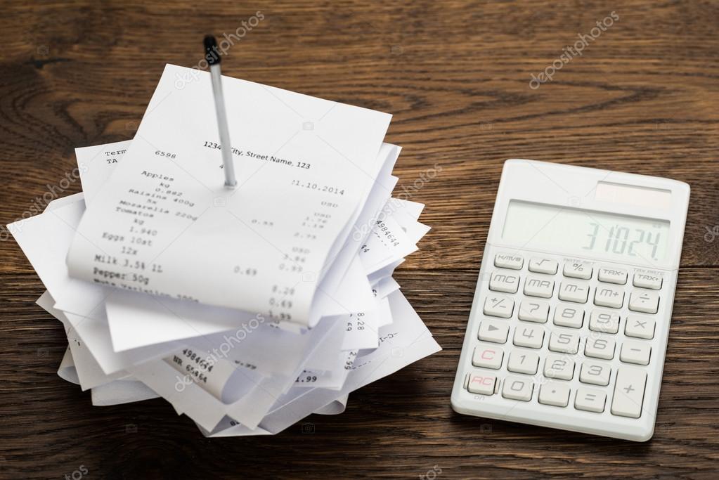 Receipts With Calculator On Table