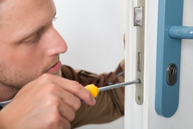 Carpenter Repairing Door Lock clipart