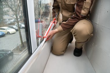 Person Applying Silicone Sealant clipart