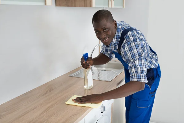 Homem limpeza cozinha bancada — Fotografia de Stock