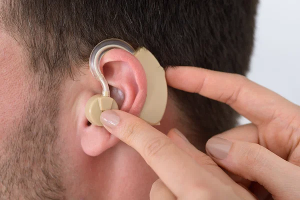 Hands Inserting Hearing Aid — Stock Photo, Image