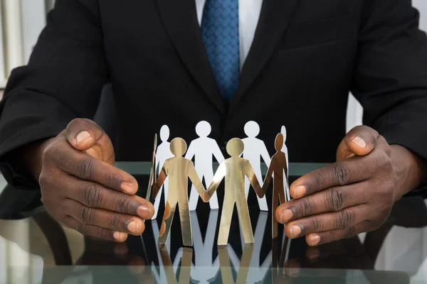 Businessman Protecting Paper People — Stock Photo, Image