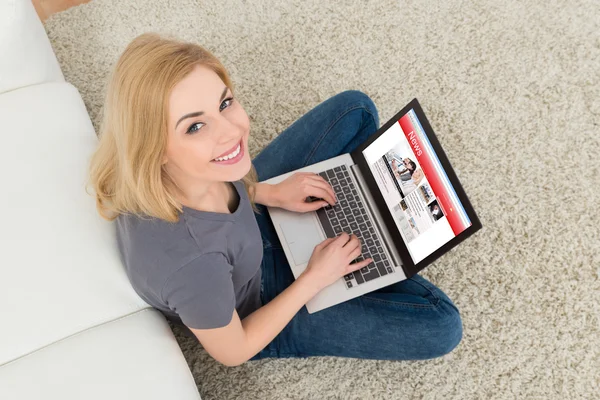 Vrouw met nieuws op Laptop — Stockfoto