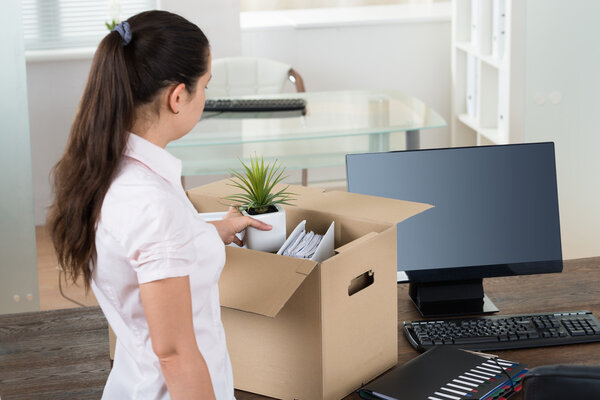 Businesswoman Packing Belongings