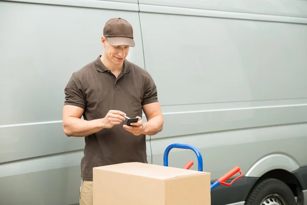 Delivery Man Checking List On Mobile Phone — Stock Photo, Image