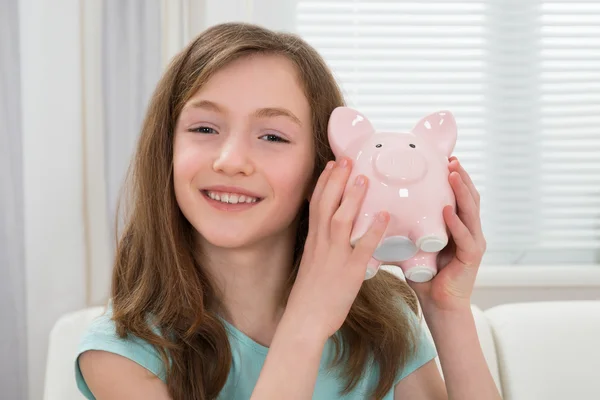 Meisje bedrijf piggy bank — Stockfoto