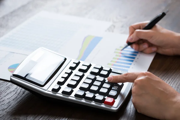 Businesswoman Analyzing Financial Report With Calculator — Stock Photo, Image