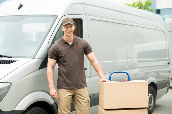 Delivery Man With Cardboard Boxes On Trolley — Stock Photo, Image