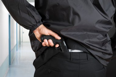 Bodyguard Removing Handgun clipart