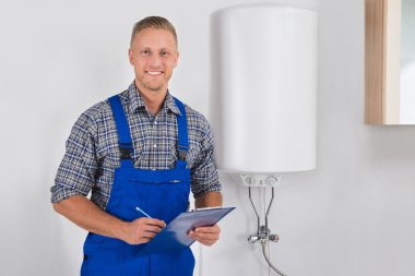 Plumber Holding Clipboard And Pen clipart