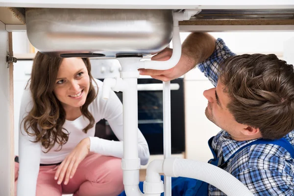 Mujer mirando como trabajador trabajando — Foto de Stock