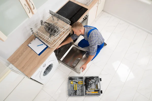 Worker With Toolbox Repairing Dishwasher — Stock Photo, Image
