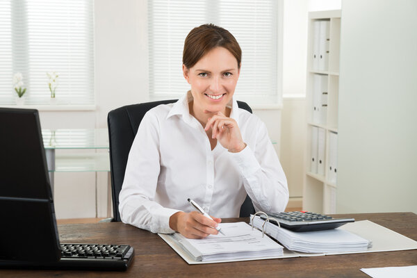 Businesswoman Calculating Invoice