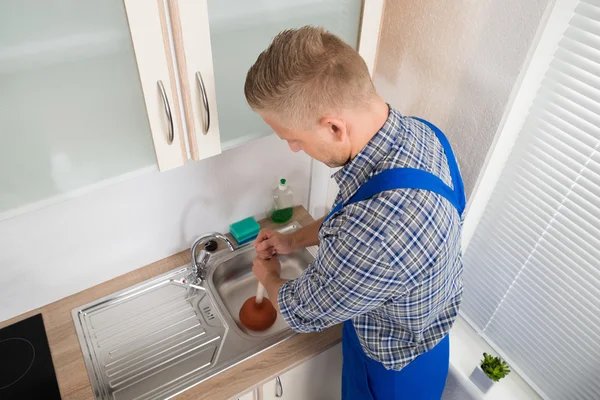 Plumber Using Plunger In Sink — Stock Photo, Image
