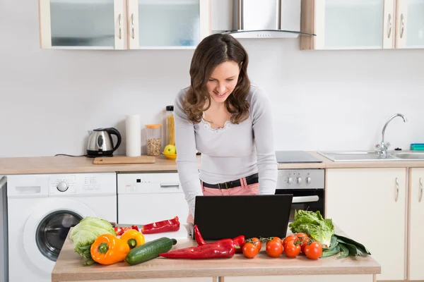 Mujer buscando receta en el ordenador portátil — Foto de Stock