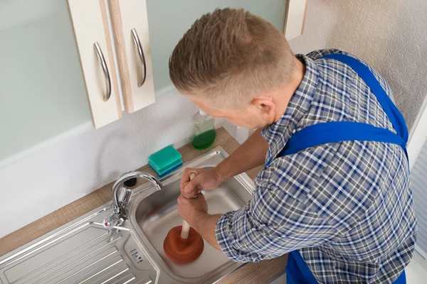 Worker Pressing Plunger In Sink — Stock Photo, Image