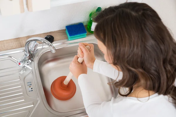 Woman Using Plunger In Sink — Stock Photo, Image
