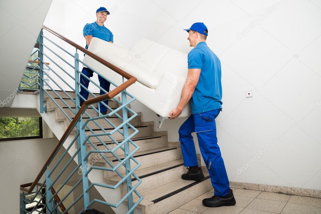 Male Movers Carrying Sofa