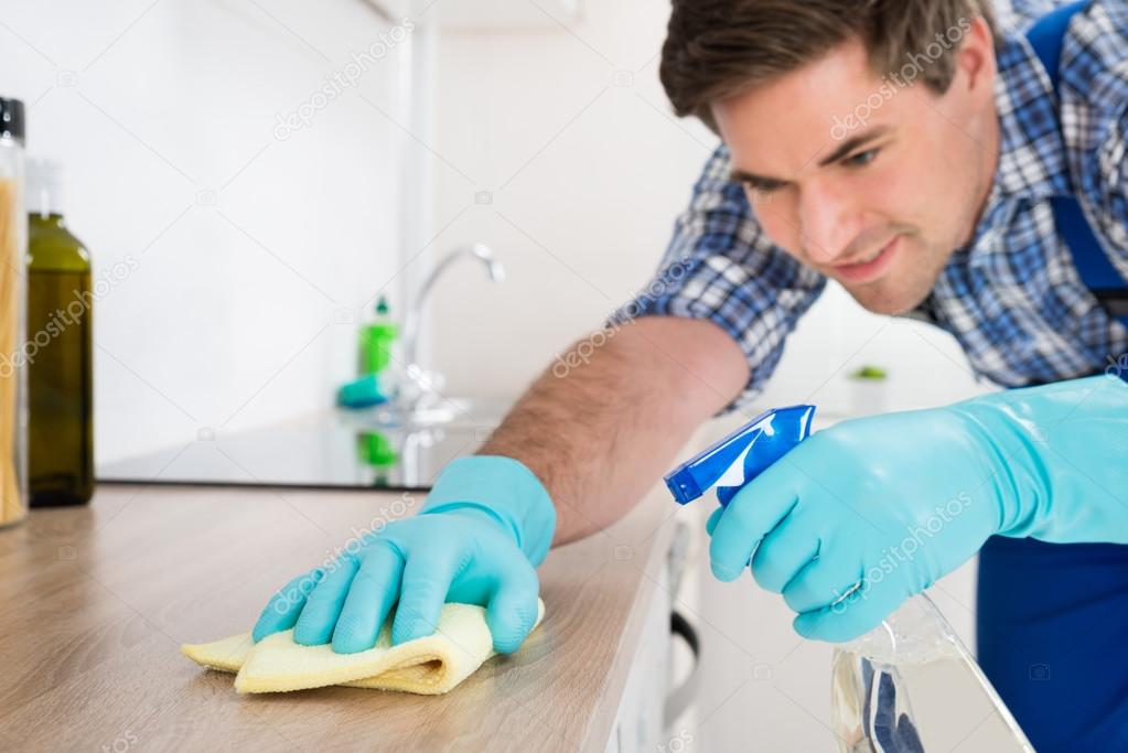 Worker Cleaning Countertop