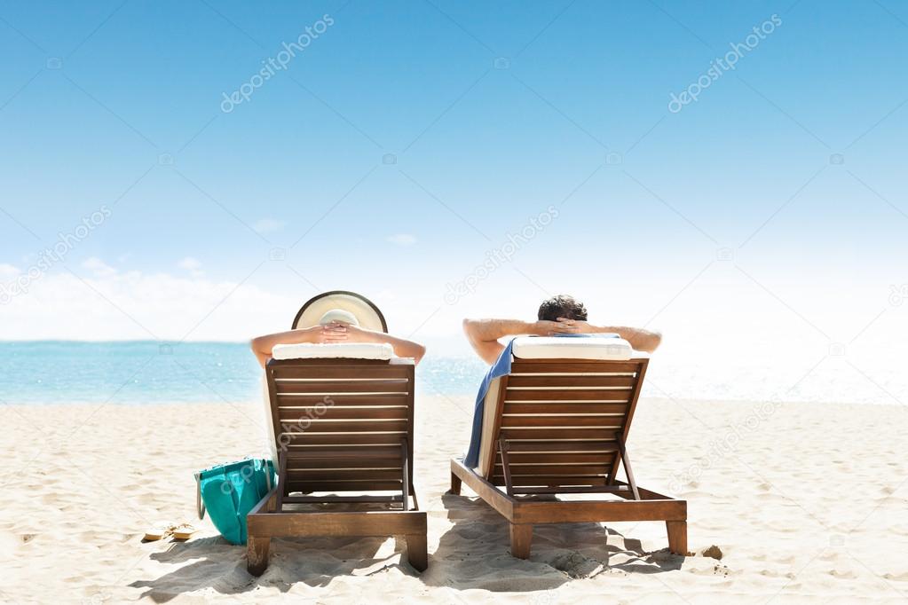Couple Lying On Lounge Chair