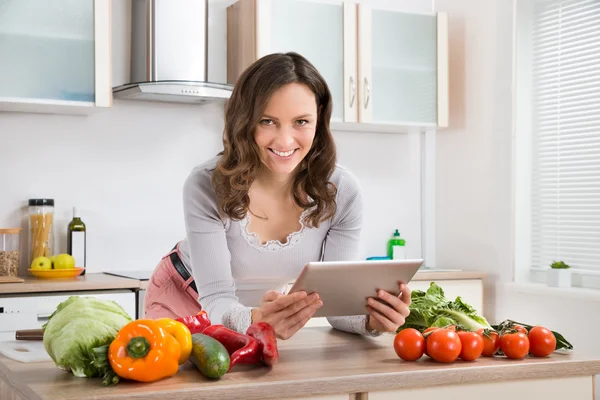 Mujer con tableta digital y verduras — Foto de Stock