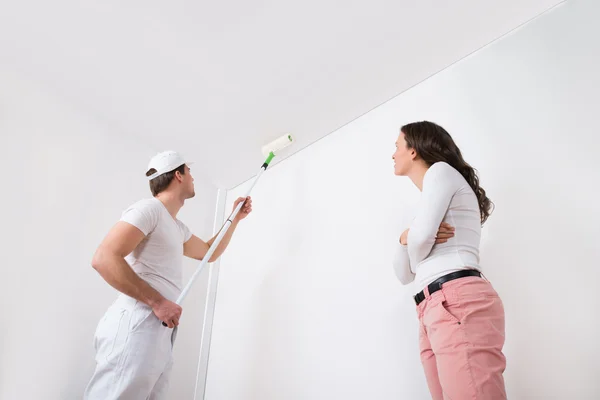 Woman Looking At Painter Painting On Wall — Stock Photo, Image
