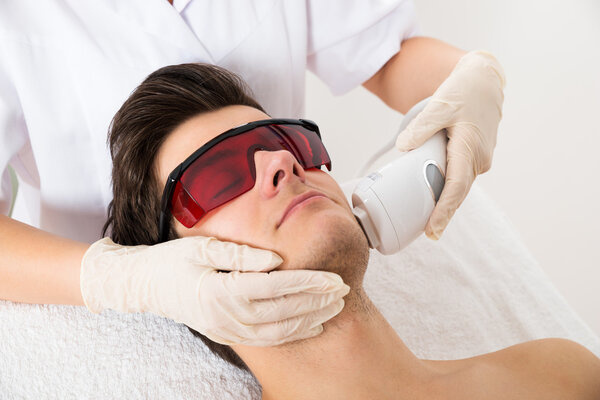 Beautician Giving Laser Epilation Treatment To Face