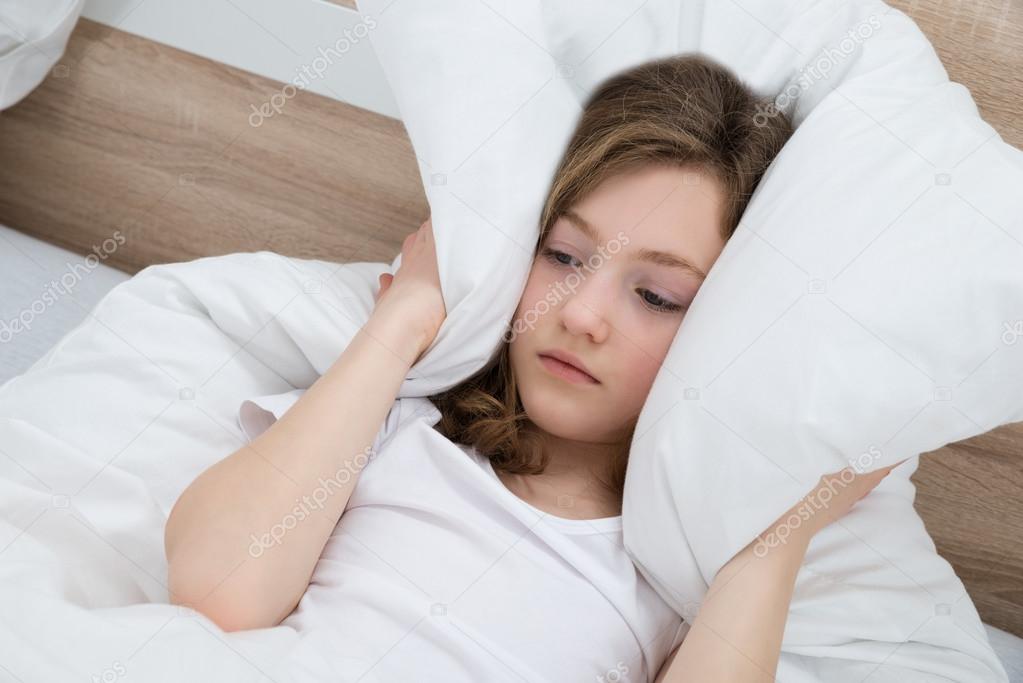 Girl Covering Ears With Pillow