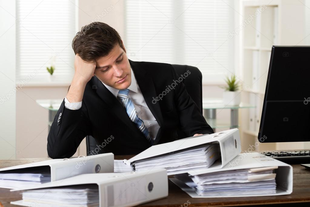 Businessman With Folders Working