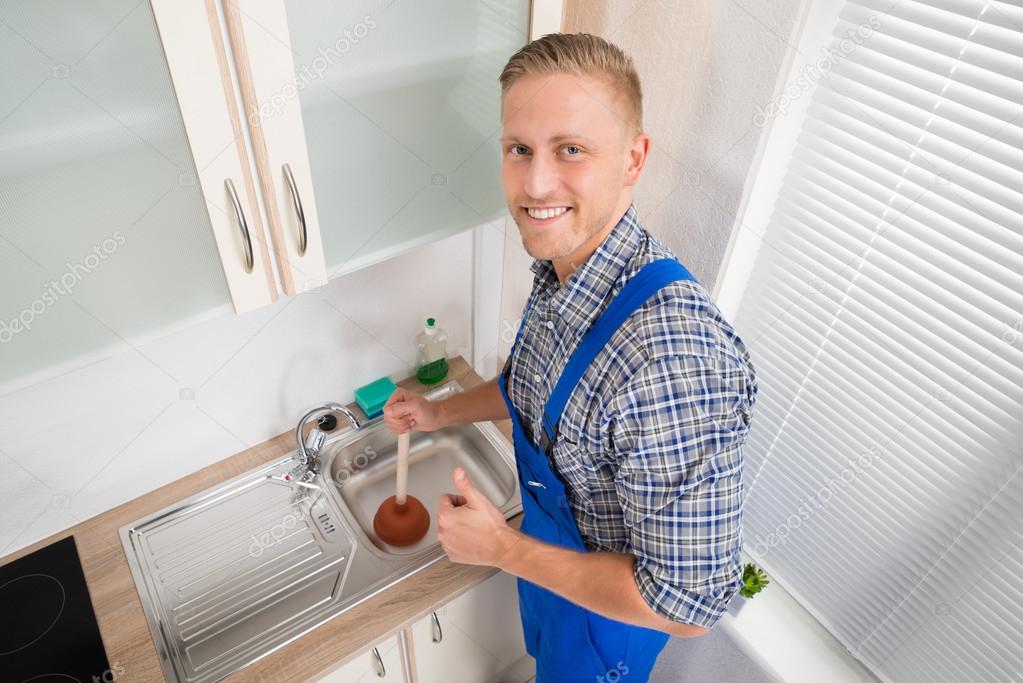 Plumber With Plunger In Kitchen