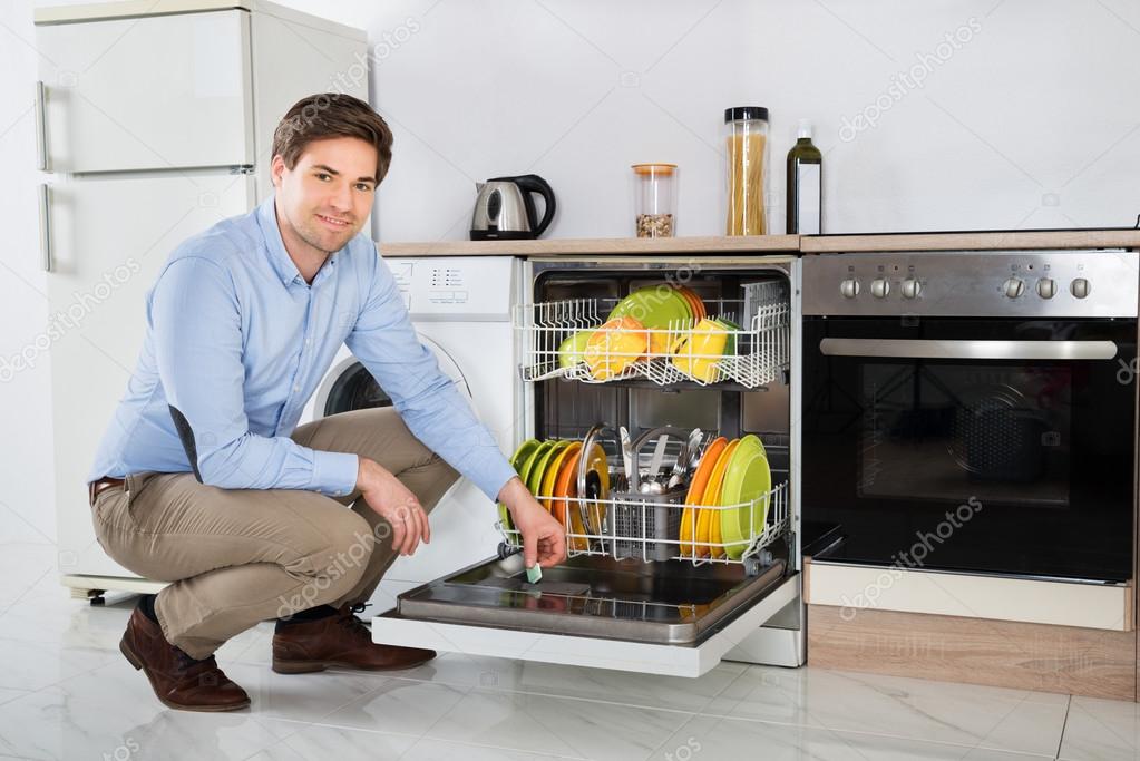 Man Putting Dishwasher Soap Tablet In Dishwasher Box — Stock Photo