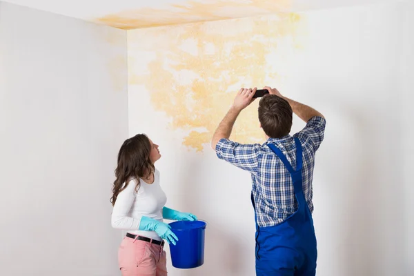 Handyman With Woman Photographing Ceiling — Stock Photo, Image