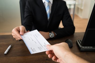Businessman Giving Cheque To Other Person clipart