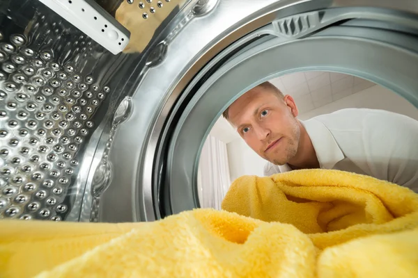 Man Putting Yellow Towel — Stock Photo, Image