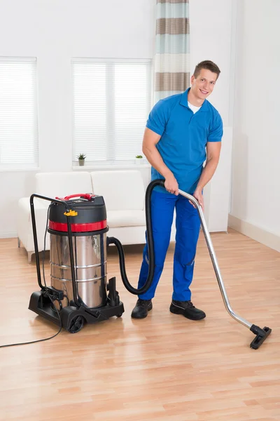 Male Janitor Vacuuming Floor — Stock Photo, Image