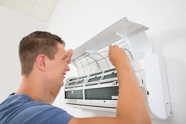 Homem limpeza sistema de ar condicionado — Fotografia de Stock